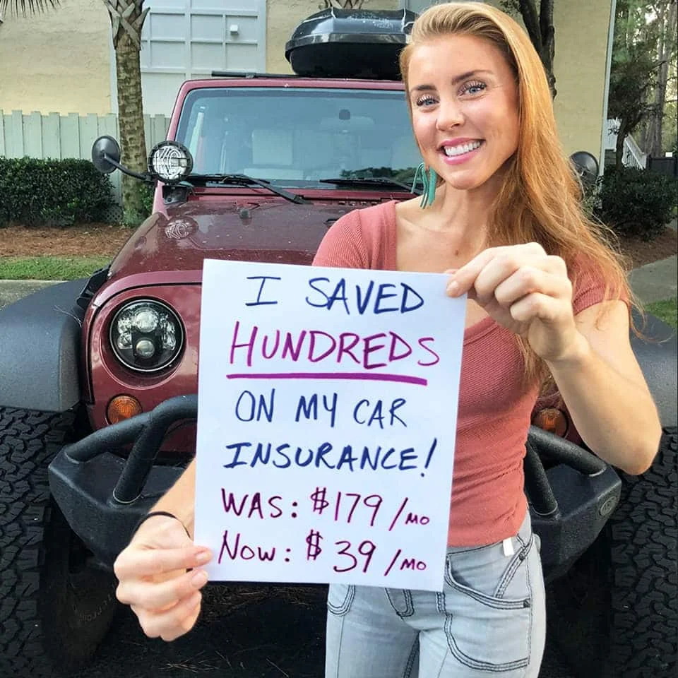 Woman holding a sign showing car insurance savings